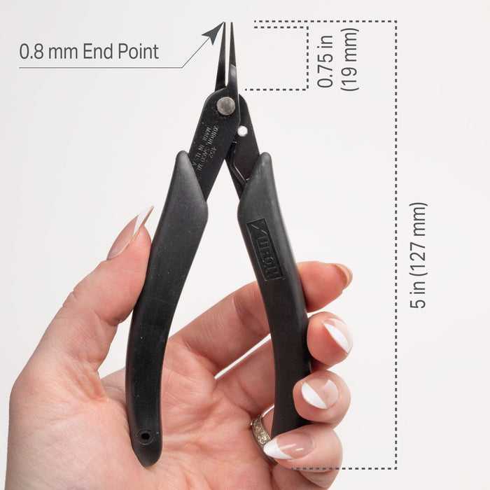 Black pliers held in a hand with measurements indicated on a white background